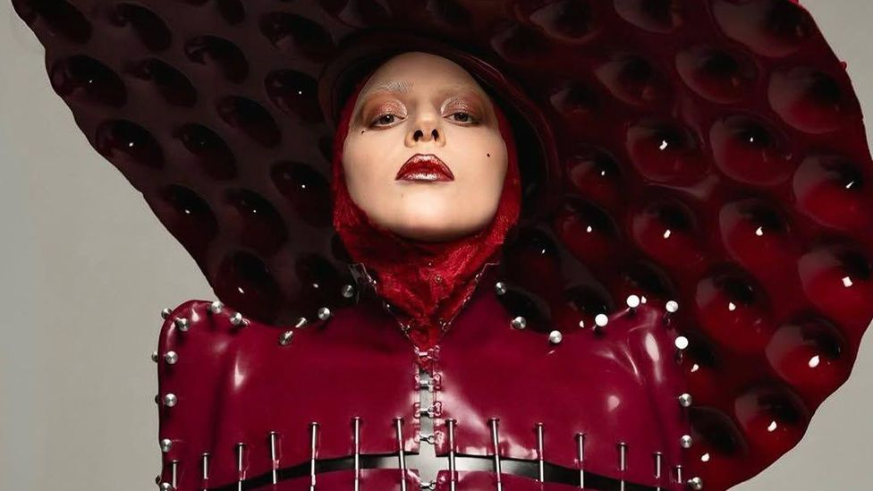 Lady Gaga In red leather posing for her latest hit, Abracadabra